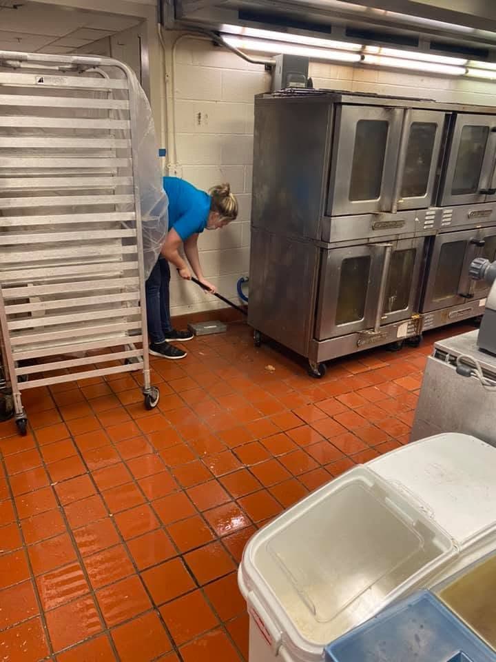 A G & J's technician detailing a commercial kitchen floor.